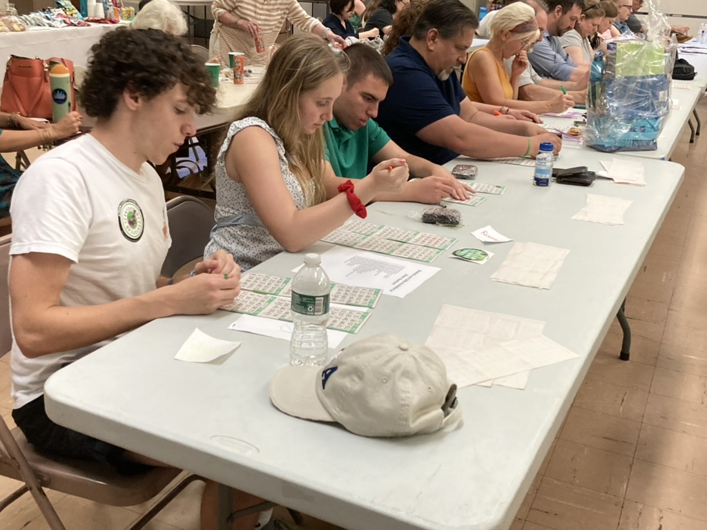 Over a dozen people playing bingo.